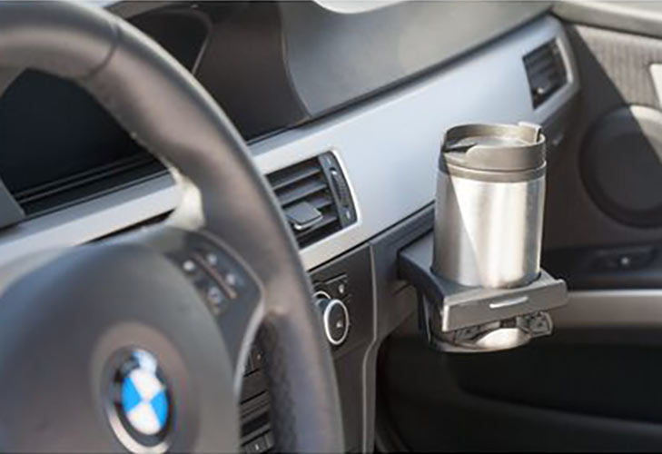 Reusable metal coffee cup in car cup holder
