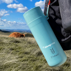 Branded sustainable reusable Swheat bottle clipped onto a backpack 