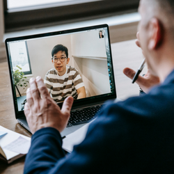 Man being mentored on a laptop screen 