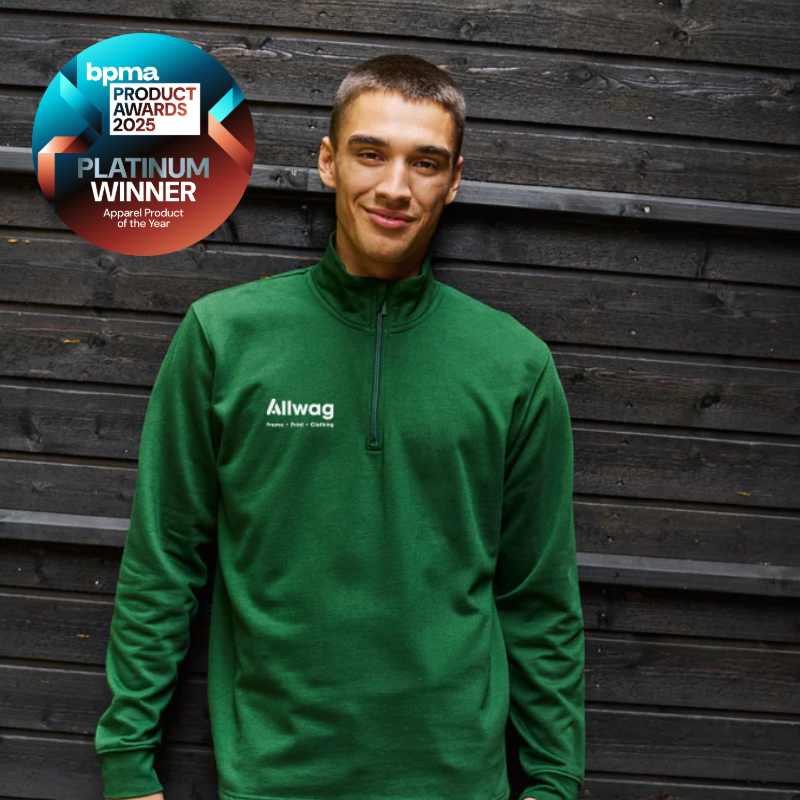 Model wearing a green branded quarter zip sweatshirt, Platinum Winner at the BPMA Product Awards 2025 for promotional apparel.
