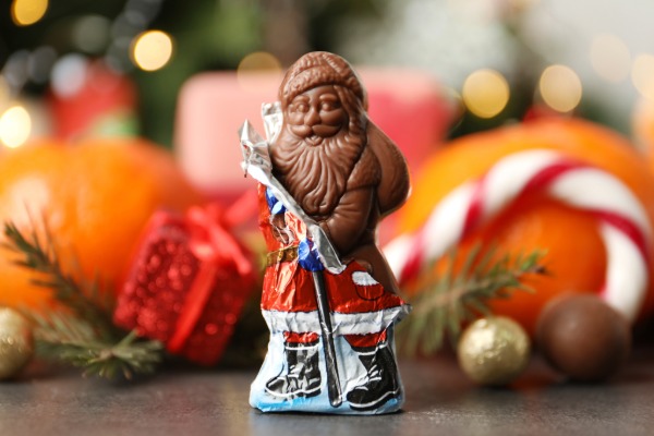 A chocolate figure shaped like Père Noël (Santa Claus), wrapped in festive foil