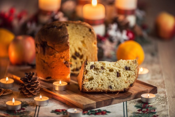 Traditional Italian Christmas panettone cake sliced open to show its light, airy texture with raisins and candied fruit.