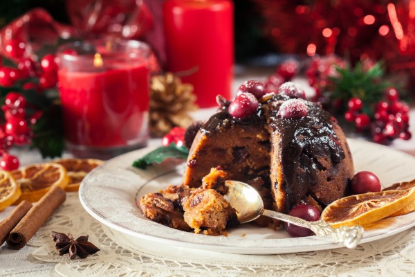 Traditional UK Christmas pudding topped with dusted with festive icing sugar.