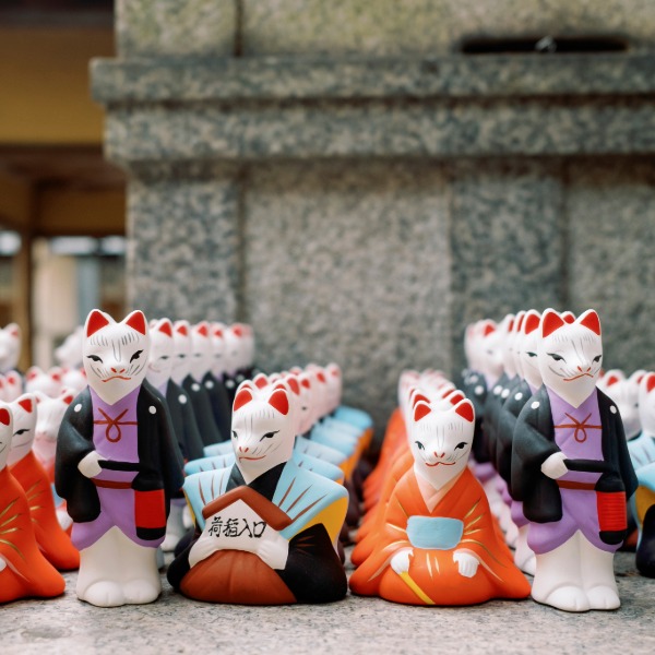 Ornaments depicting Japanese fox spirits, known as kitsune, often associated with folklore and Shinto traditions.