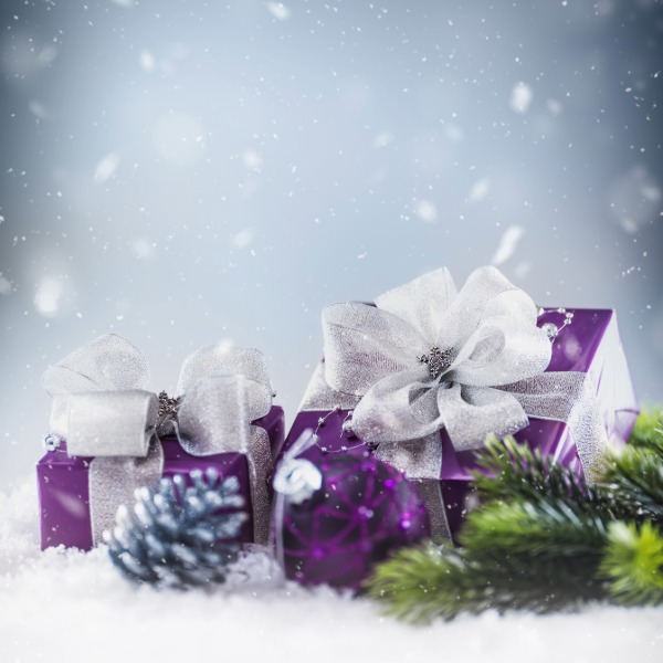 Purple gifts wrapped with silver and white ribbons, arranged neatly for a festive display.