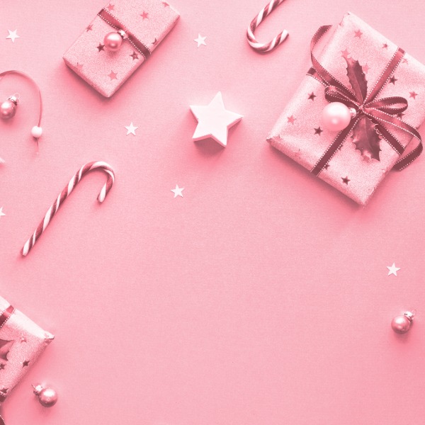 Pink gifts decorated with candy canes and star-shaped accents, arranged for a festive holiday display.